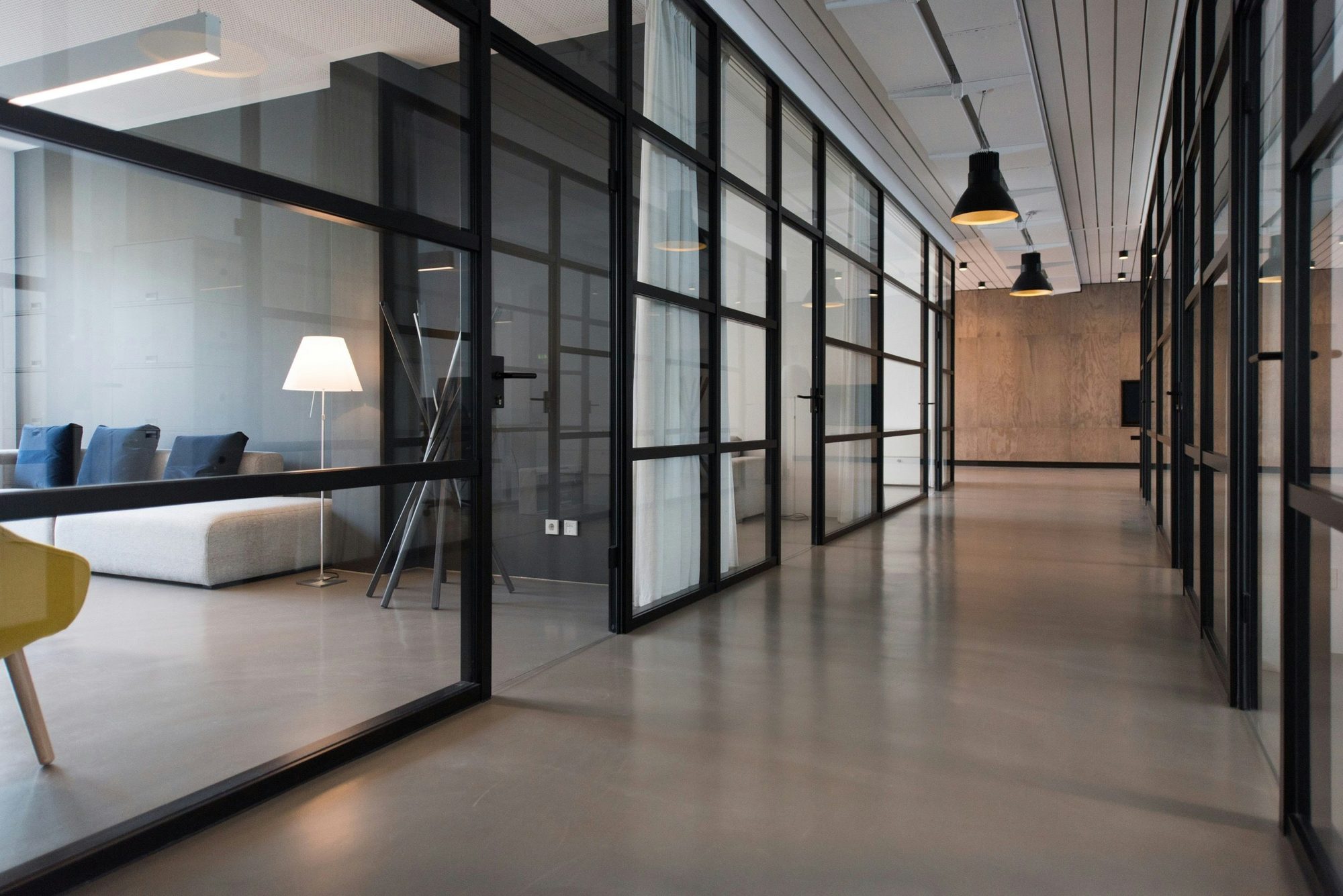 A modern office with glass walled meeting rooms