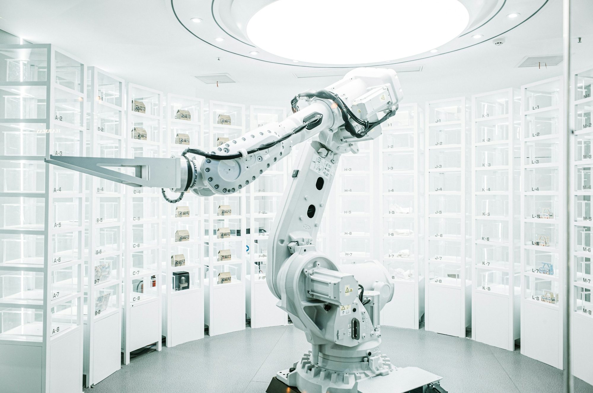 A white robotic arm in a bright showroom