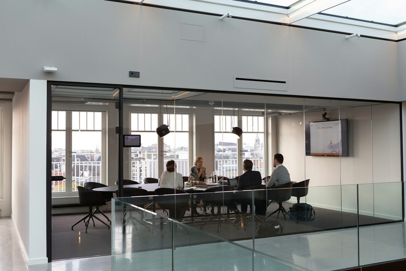 A meeting in a glass walled boardroom